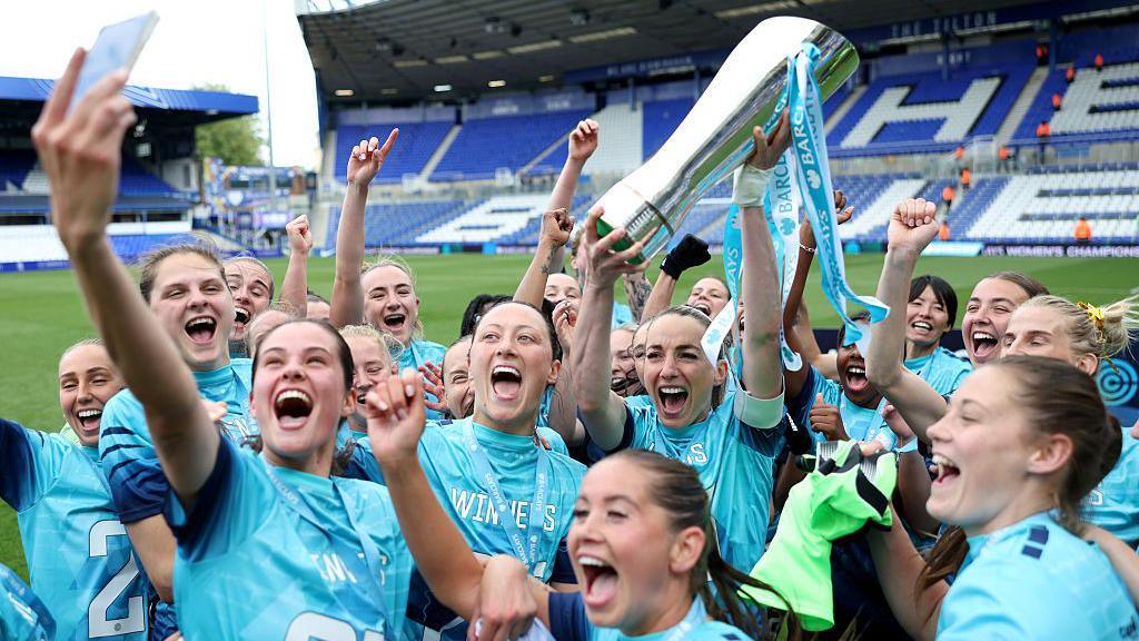 London City Lionesses celebrating their promotion to the WSL with the Women's Championship trophy