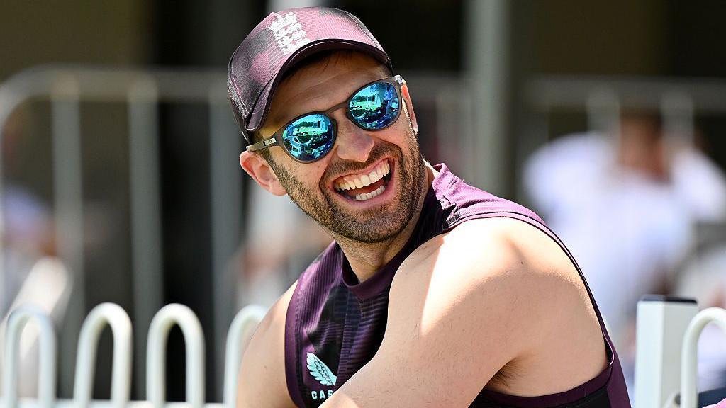 Mark Wood grins on the sidelines during England's Ashes practice match