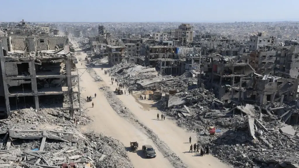 A destroyed city street with buildings reduced to rubble