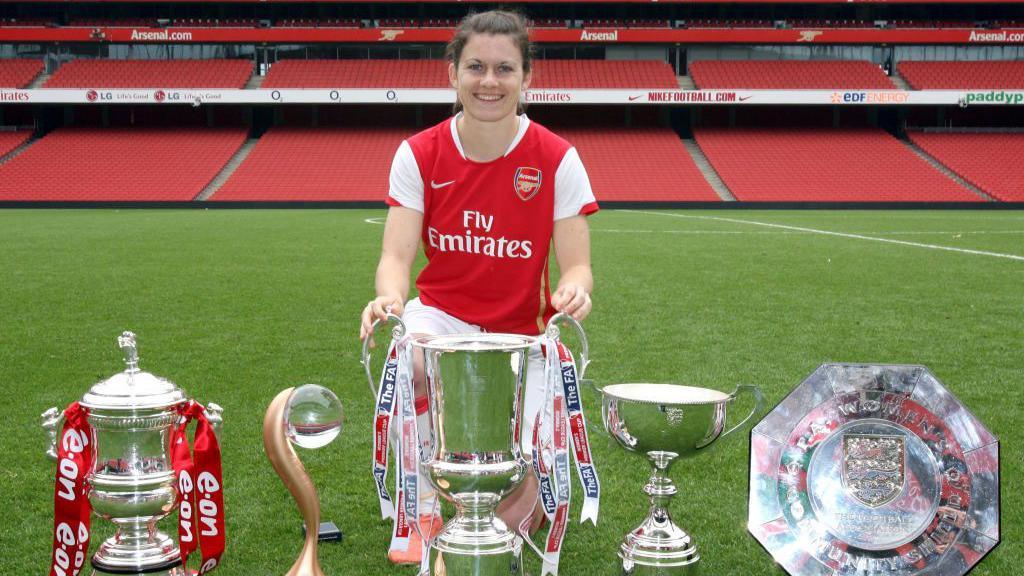 Karen Carney poses at Emirates Stadium with her trophy haul in 2006-07
