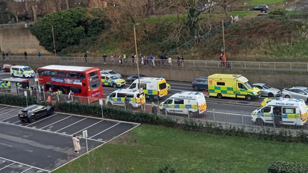 Ambulance and police cars beside the bus