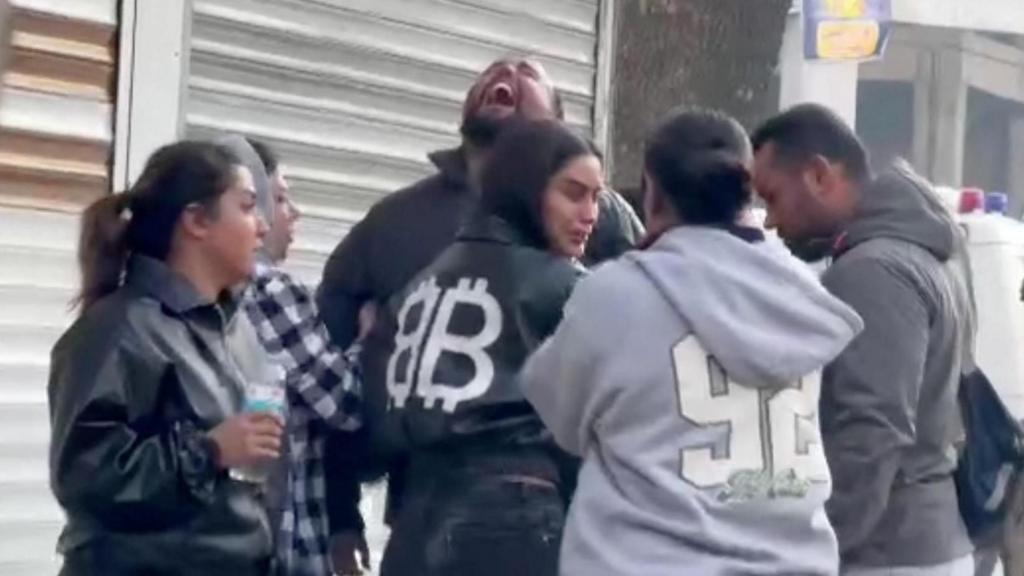 People react near residential buildings, the site of air strikes in the Resalat neighborhood, in Tehran, Iran, in this screengrab obtained from a handout video released March 9, 2026. Iranian Red Crescent Society/Handout via REUTERS