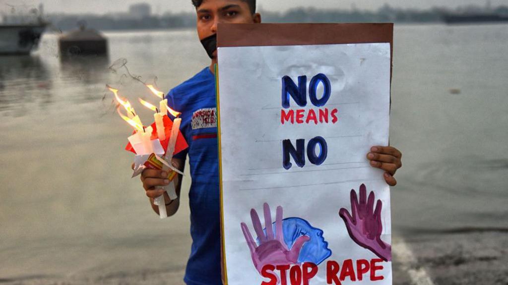 KOLKATA, INDIA - 2019/11/30: A protester holds a placard that says Stop Rape and lighting Candles during a Protest seeking for justice and against the Gang Rape case of Priyanka Reddy. Priyanka Reddy, A Lady Veteran (26 yrs old) from Hyderabad, India was brutally Gang Raped & Burnt alive on 28th November by Four Truck driver on a Highway as per Police Information. Latest update says, a magistrate in Telangana's Shadnagar town sent all four accused to judicial custody for 14 days. (Photo by Avishek Das/SOPA Images/LightRocket via Getty Images)