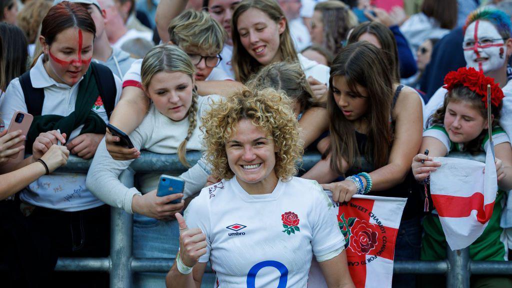 Ellie Kildunne gives a thumbs up in front of fans 