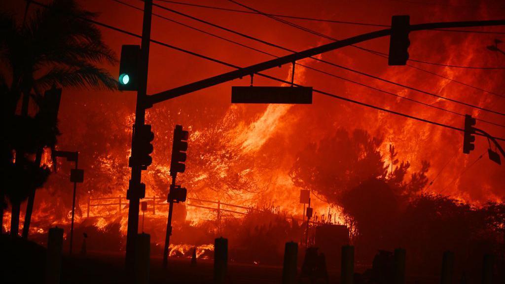  Flames overtake an intersection of the Palisades Fire on 7 January 2025