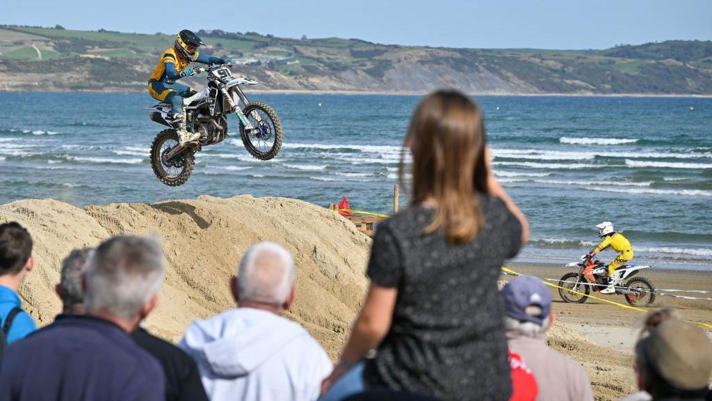 Spectators watching the motocross bikes on weymouth beach