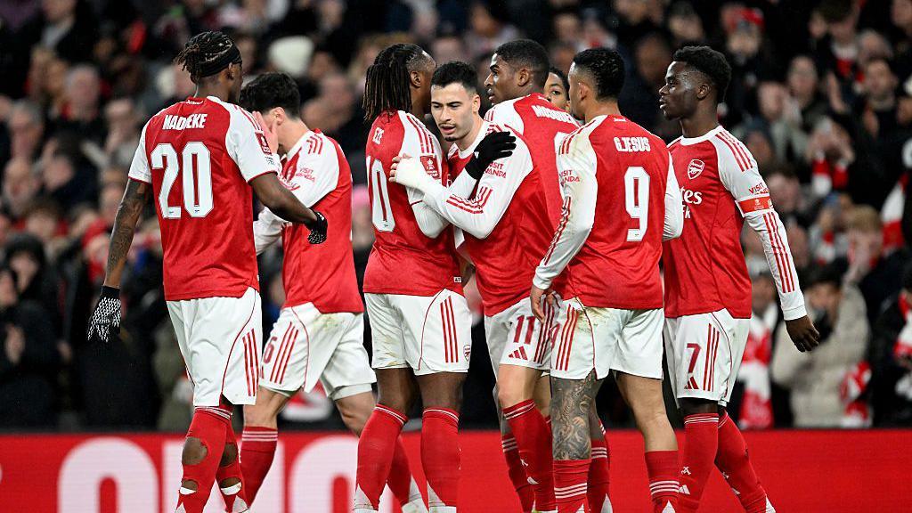 Arsenal players celebrate scoring against Wigan in the FA Cup