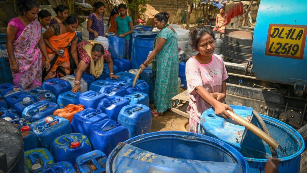 NEW DELHI, INDIA - JUNE 6: People fill water from a Delhi Jal Board Tanker amid water scarcity at Anand Parbat on June 6, 2024 in New Delhi, India. (Photo by Sanchit Khanna/Hindustan Times via Getty Images)