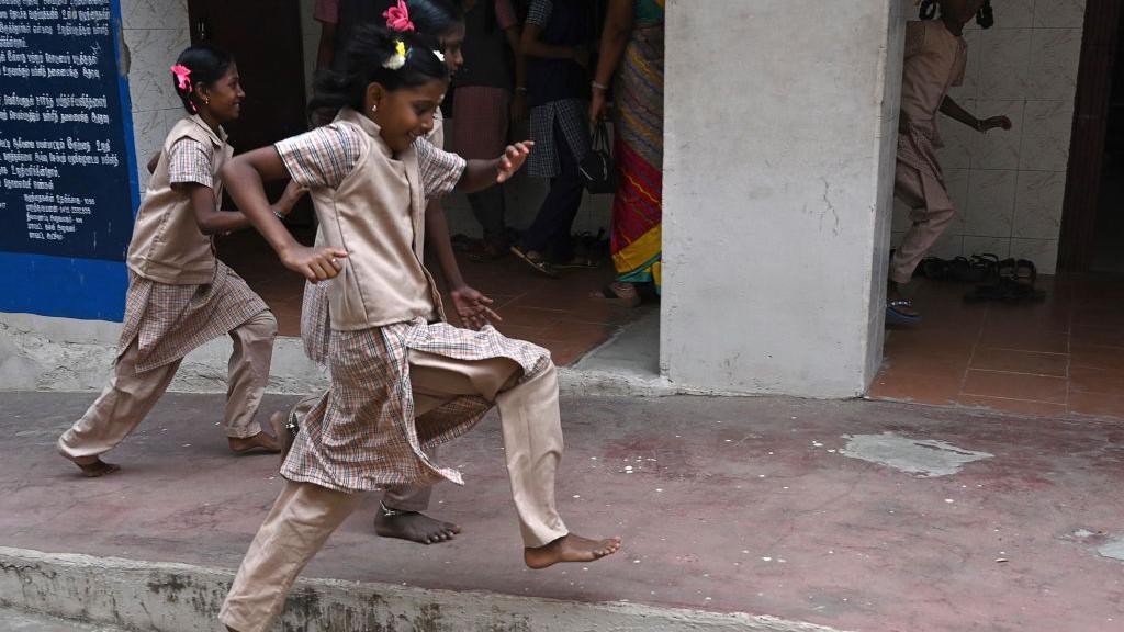 School students wearing beige colour uniform in a Tamil Nadu school.
Students arrive to attend classes after the reopening of schools closed as a preventive measure to curb the spread of the Covid-19 coronavirus, at a school in Madurai on February 01, 2022. (Photo by Arun SANKAR / AFP) (Photo by ARUN SANKAR/AFP via Getty Images)
