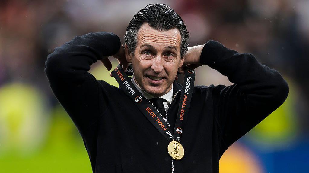 Unai Emery, head coach of Aston Villa FC, adjusts his medal during the award ceremony following the Uefa Europa League 2025-26 final football match between SC Freiburg and Aston Villa.