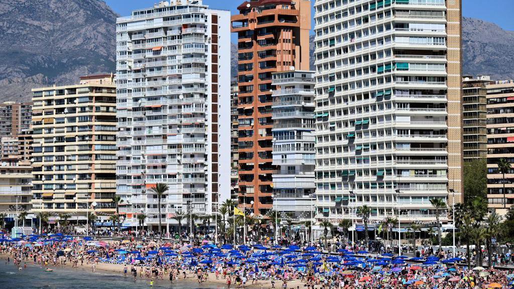 Holidaymakers crowd Levante Beach in Benidorm on 8 April 2023.