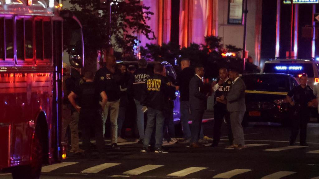 Police officers stand on a street