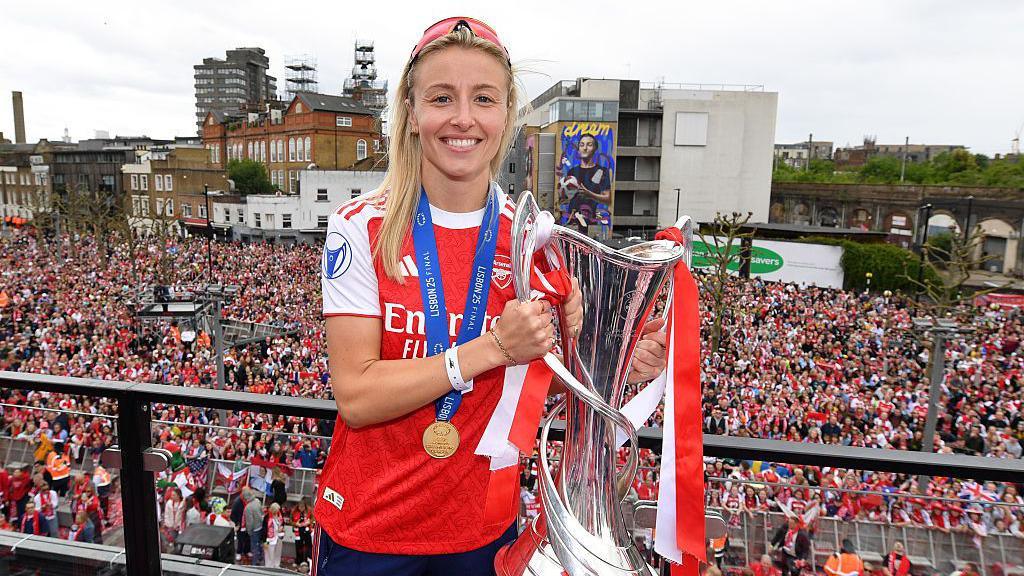 Leah Williamson holding the Women's Champions League trophy
