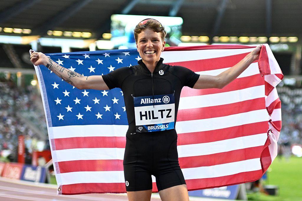 Nikki Hiltz holding up the American flag after a race