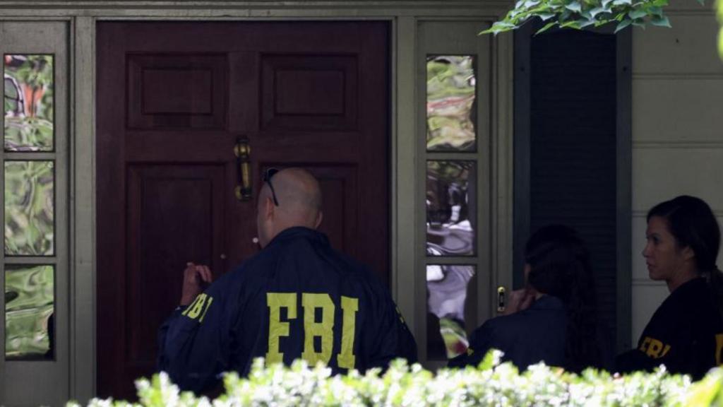 FBI agents at the door of the home of John Bolton