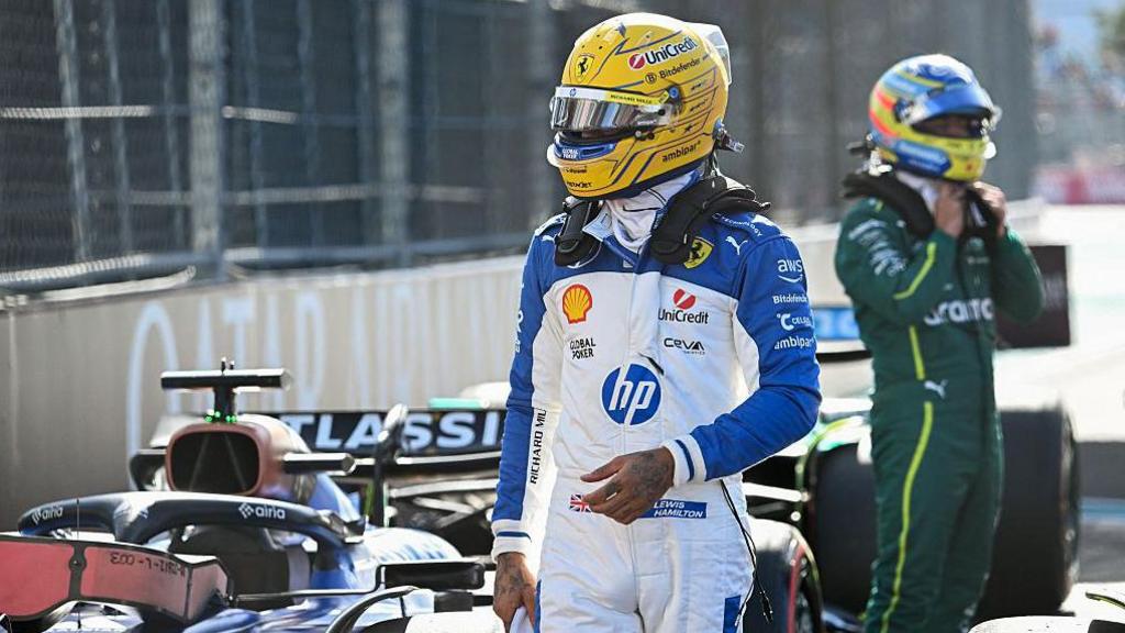 Lewis Hamilton wear the blue and white race suit