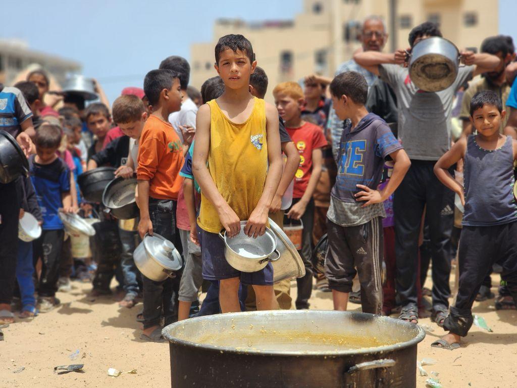 Children wait for food aid in Rafah in southern Gaza