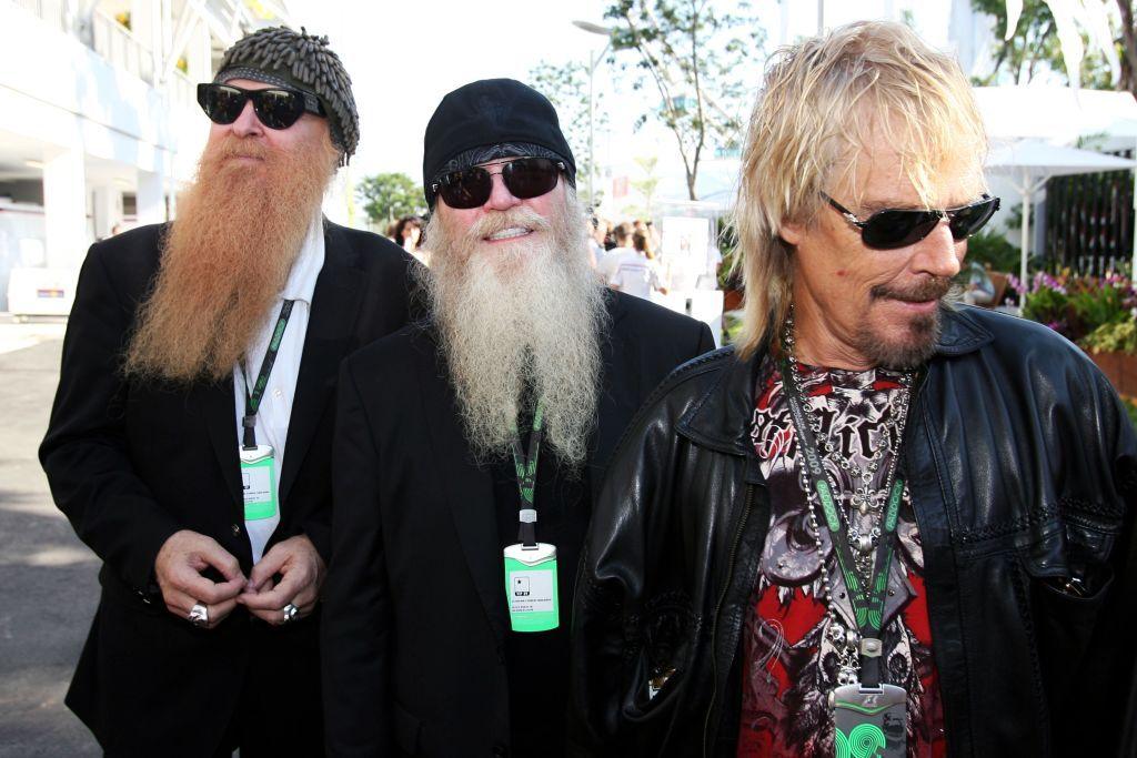 ZZ Top lead vocalist Billy Gibbons, bassist Dusty Hill and drummer Frank Beard sport lengthy beards and sunglasses as they walk outdoors at the Formula One World Championship in Singapore on 24 September 2009. ( 