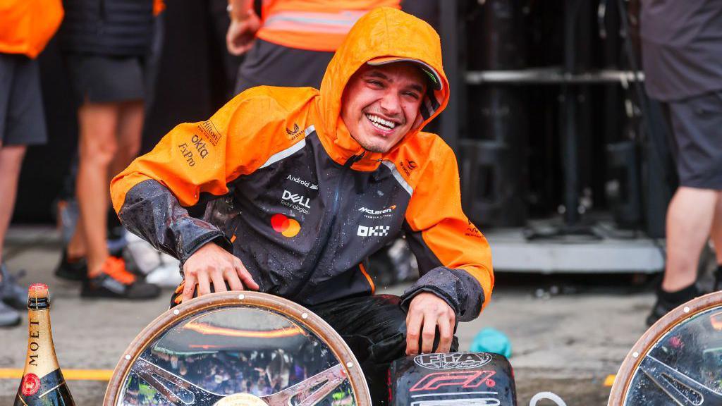 McLaren's Lando Norris celebrating his win with the McLaren team