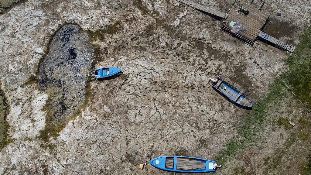Boats laying on the dried Danube river bed in front of the Calafat-Vidin bridge, connecting Bulgaria and Romania
