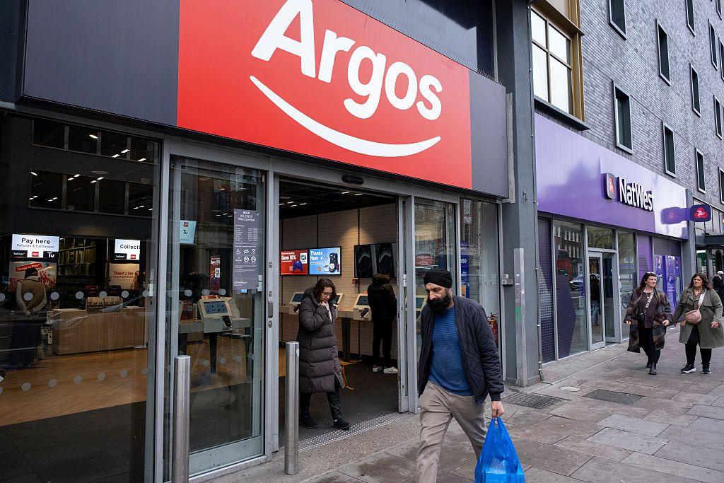 A man walks past an Argos shop 