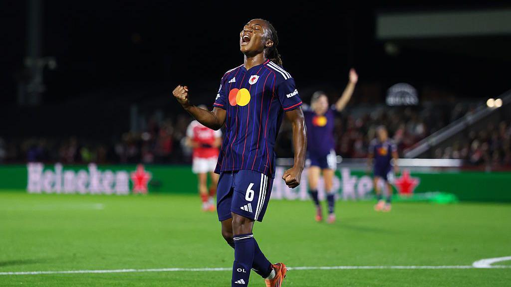 Melchie Dumornay celebrates with a clenched right fist