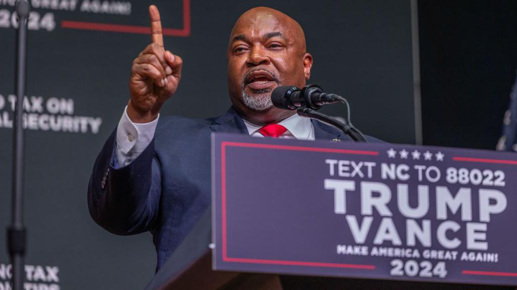 Mark Robinson, the Lt Governor of North Carolina and candidate for Governor, delivers a speech on stage before a Trump campaign event in August. 