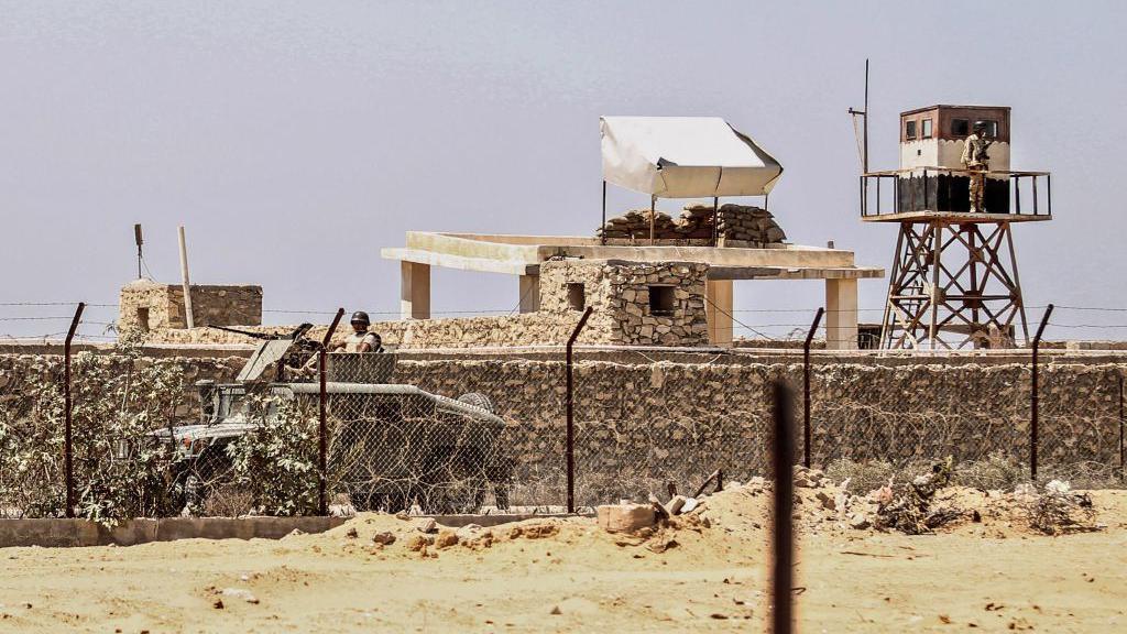 A photo taken from the southern Gaza Strip town of Rafah shows an Egyptian soldier standing guard in a watch tower