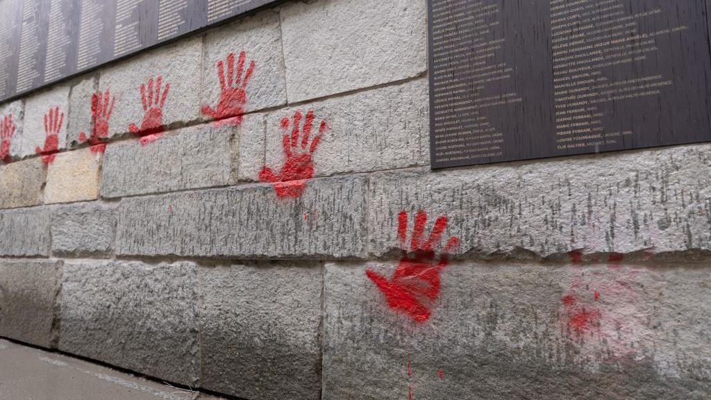 Red hand graffiti seen on the "Wall of the Righteous" (Mur des Justes) outside the Shoah memorial in Paris, on May 14, 2024, after the monument was vandalised overnight, with the president of the Representative Council of French Jewish Institutions (CRIF) denouncing the act as antisemitic.