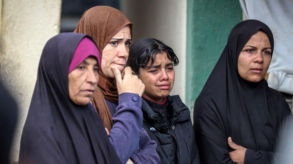 Women mourn relatives who were killed by Israeli bombardment outside the Aqsa Martyrs hospital in Deir el-Balah in the central Gaza Strip on 5 January, 2025