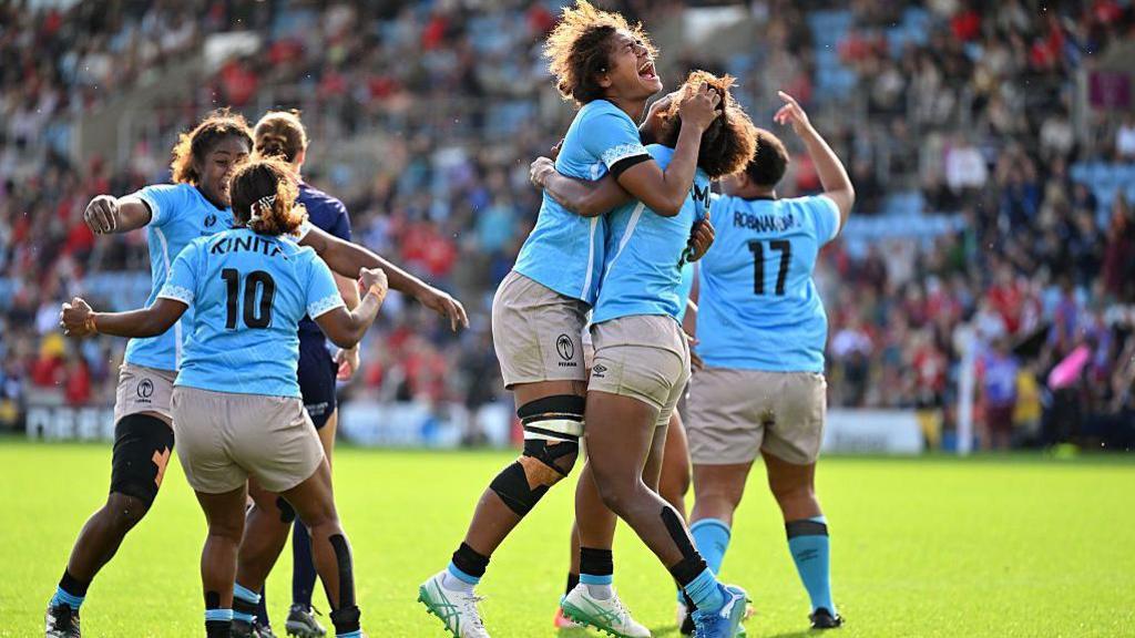 Fiji players celebrate at full-time against Wales