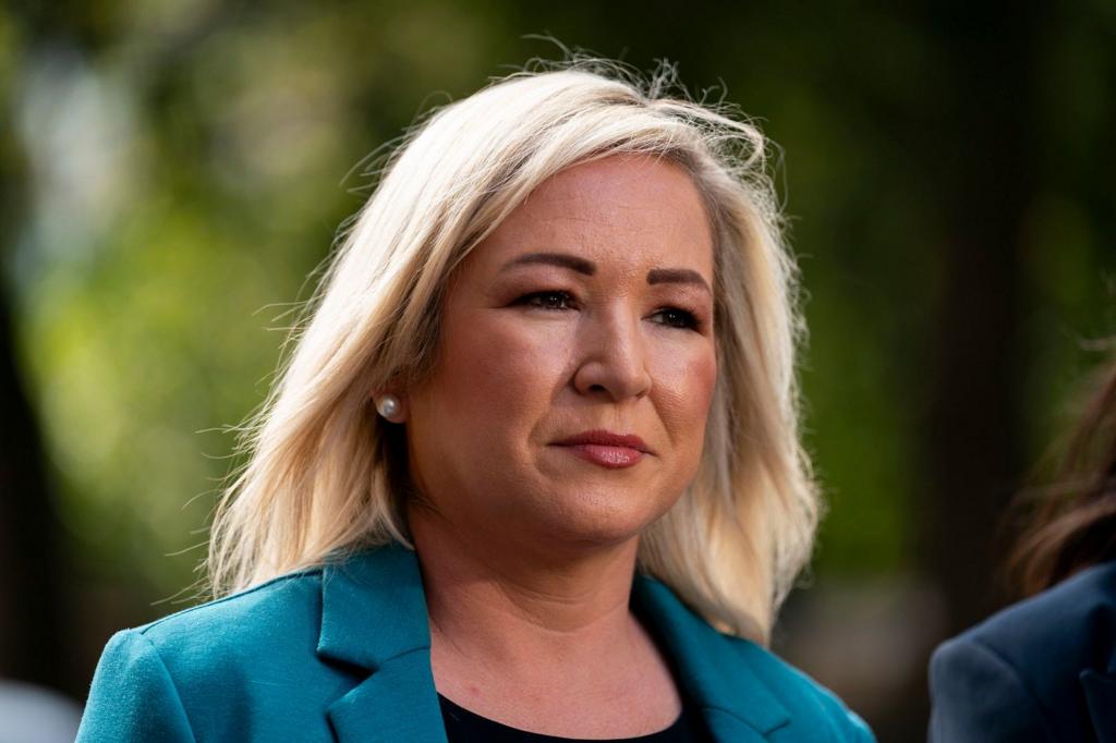 Michelle O'Neill - she has blonde hair, pearl earrings and a teal jacket.