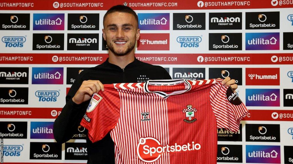 England Under-21 skipper Taylor Harwood-Bellis poses with his new Saints shirt.