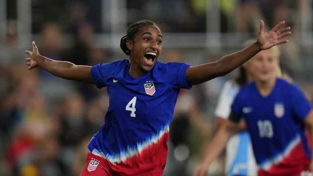 Naomi Girma celebrating on the pitch.