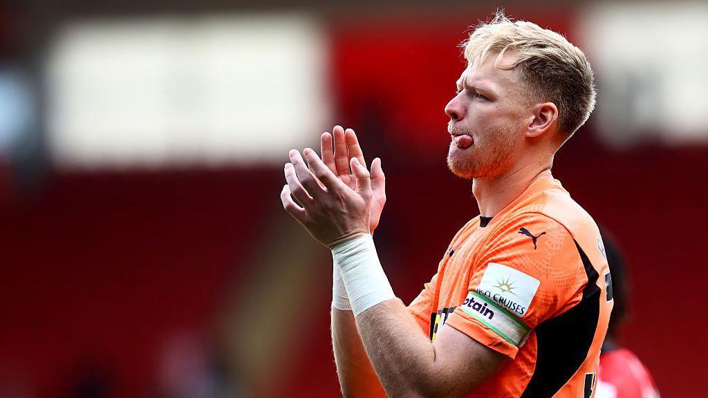Aaron Ramsdale applauds the fans