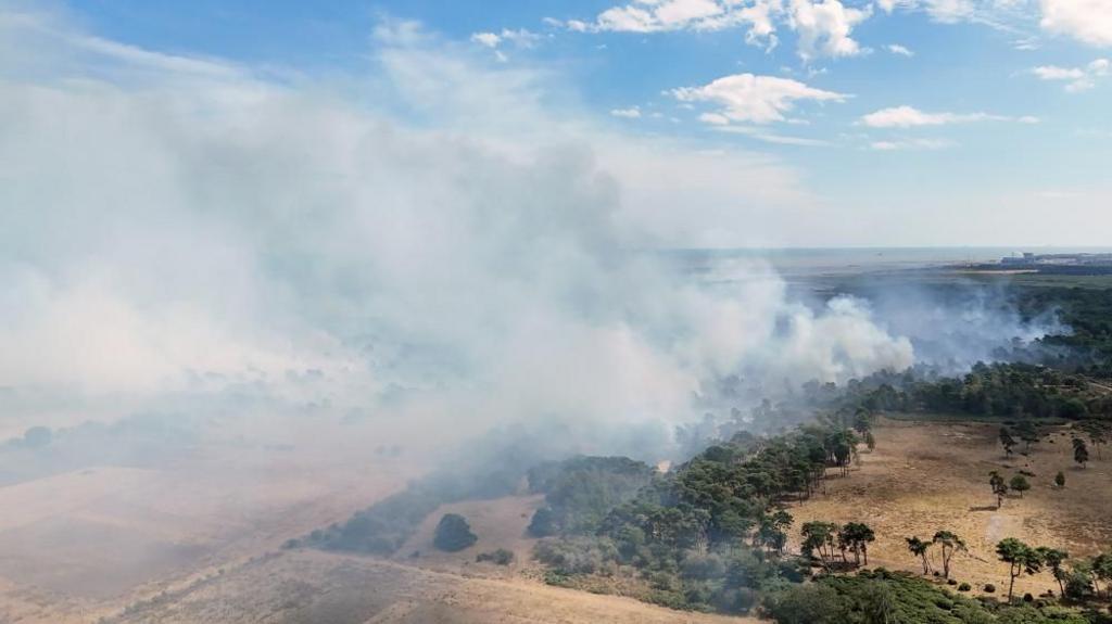 Smoke rises from a wildfire at Dunwich Heath, near Leiston