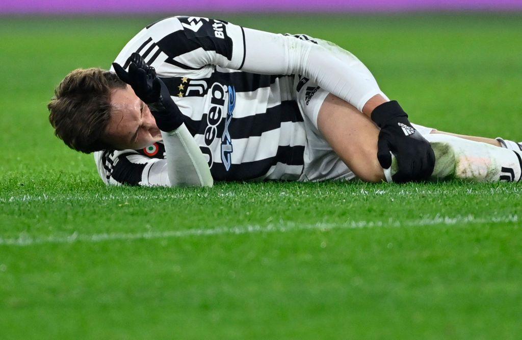 Federico Chiesa clutches his left knee after suffering an ACL injury in January 2022