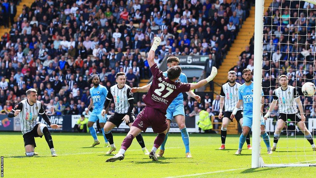 Notts County's Aden Baldwin heads home Notts County's equaliser against Boreham Wood