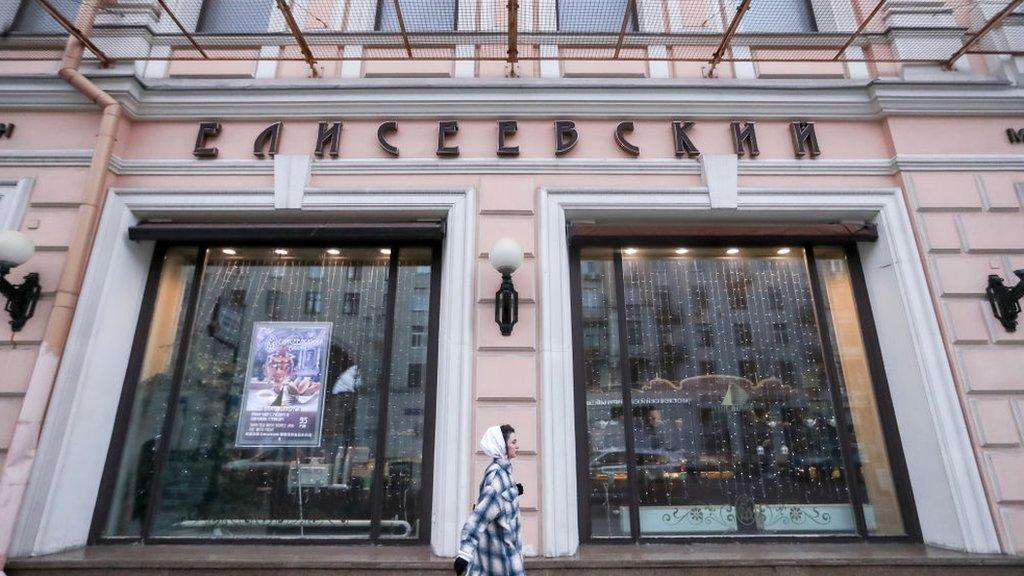 NOVEMBER 25, 2020: A woman walks past the Yeliseyevsky grocery store in Tverskaya Street, central Moscow