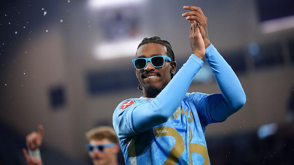 Coventry's Haji Wright celebrates their promotion by wearing a pair of sky blue sunglasses