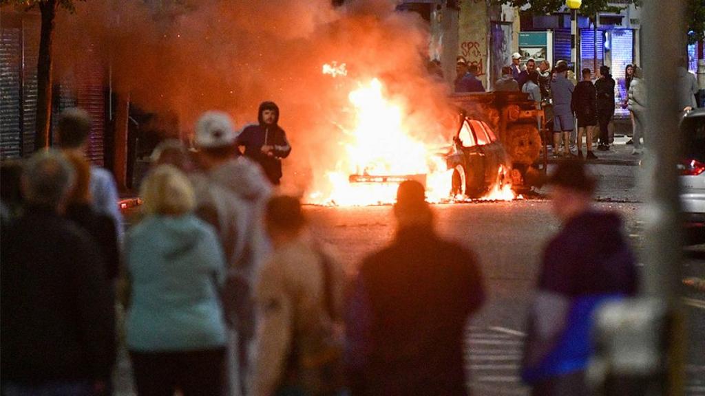 A car on fire on the streets of Belfast