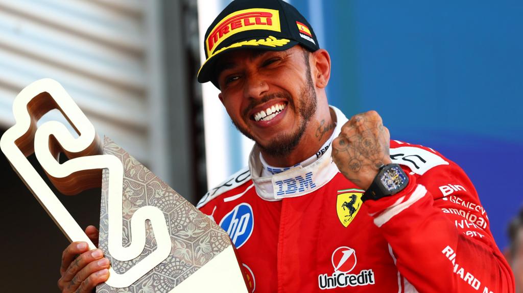 Lewis Hamilton celebrates with the trophy after winning the Barcelona-Catalunya Grand Prix