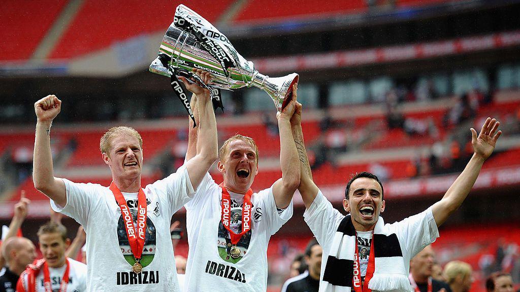 Alan Tate, Garry Monk and Leon Britton celebrate at Wembley in 2011