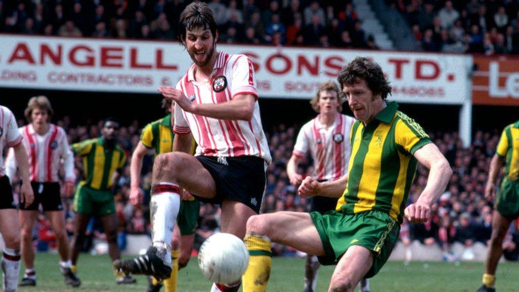 Chris Nicholl challenges West Brom's John Wile while playing for Southampton in 1979