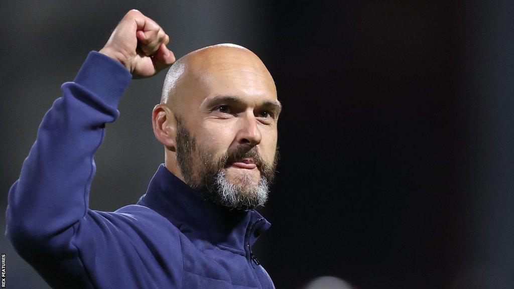 Notts County boss Luke Williams punches the air on the touchline