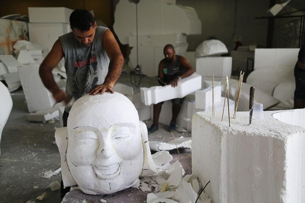 Workers at the Mangueira samba school carve figures out of polystyrene