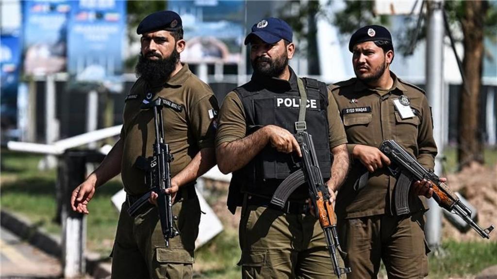 Security personnel stand guard at a security checkpost along a road temporarily closed near the Serena Hotel at the Red Zone area in Islamabad on April 20, 2026