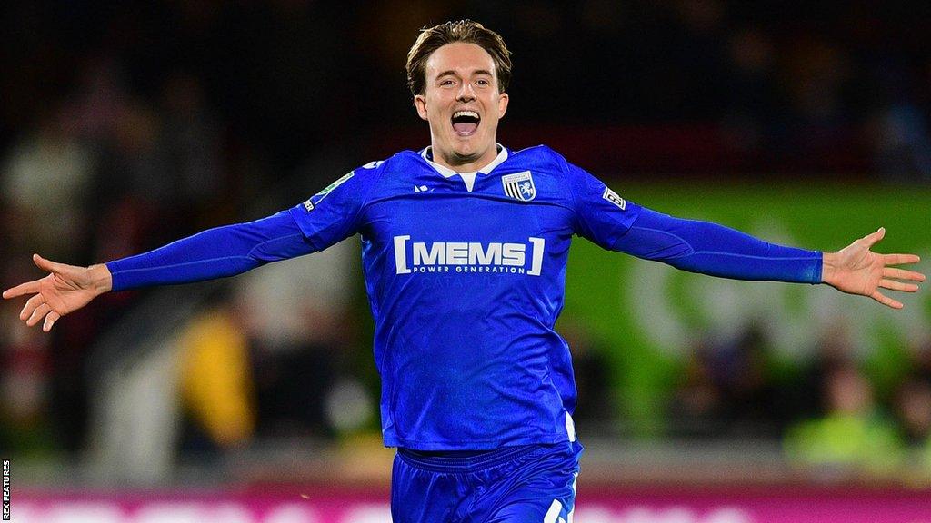 Will Wright, with his arms outstretched, celebrates scoring for Gillingham in a penalty shoot-out