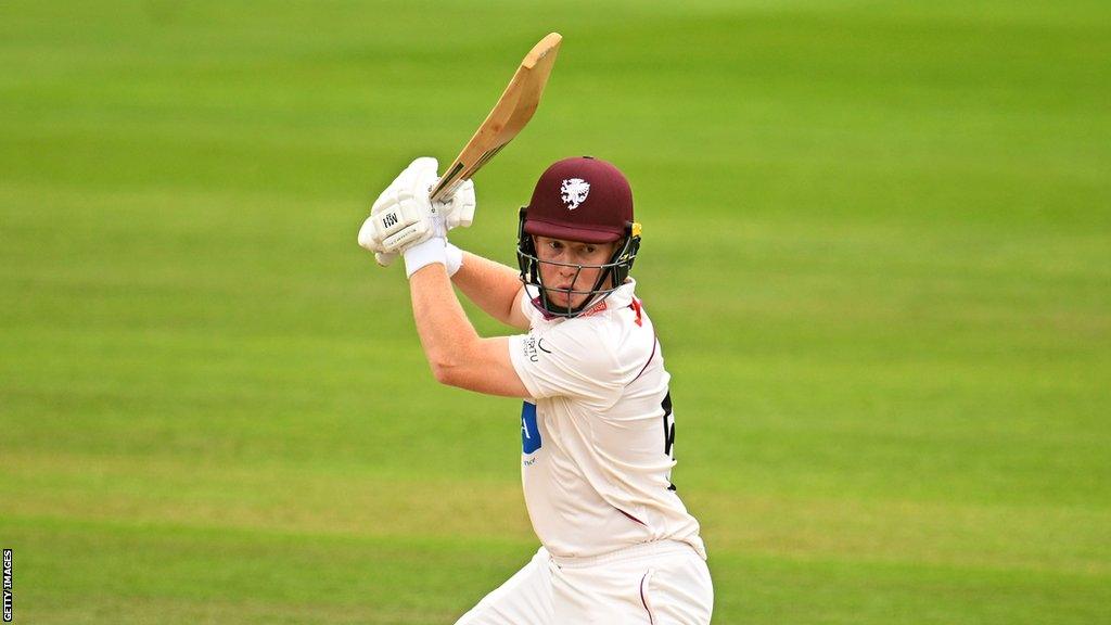 James Rew raises the bat in the air while playing for Somerset in the County Championship this season