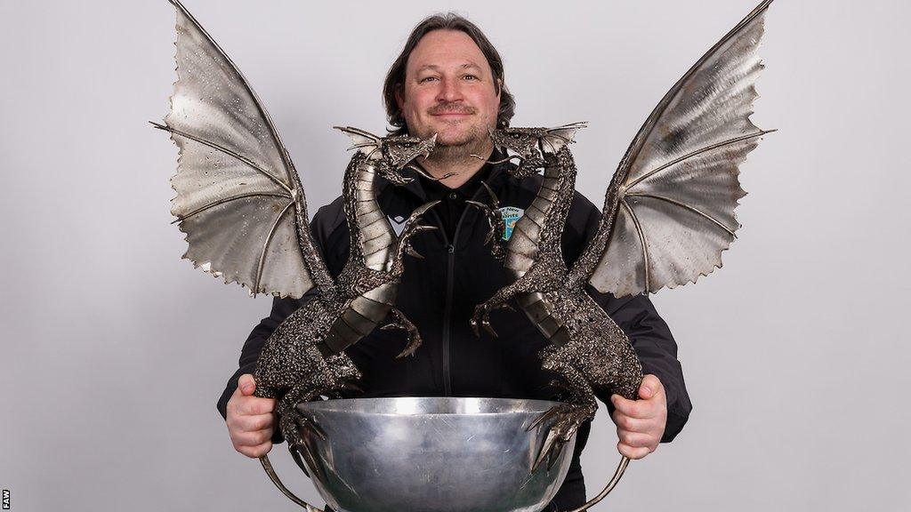 TNS manager Craig Harrison poses with Cymru Premier trophy